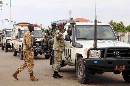 U.N. peacekeepers and South Sudan National security members ride on their truck as they protect internally displaced people during a reallocation at the United Nations Mission in South Sudan (UNMISS) compound at the UN House in Jebel, in South Sudan's capital Juba, August 31, 2016. REUTERS/Jok Solomun