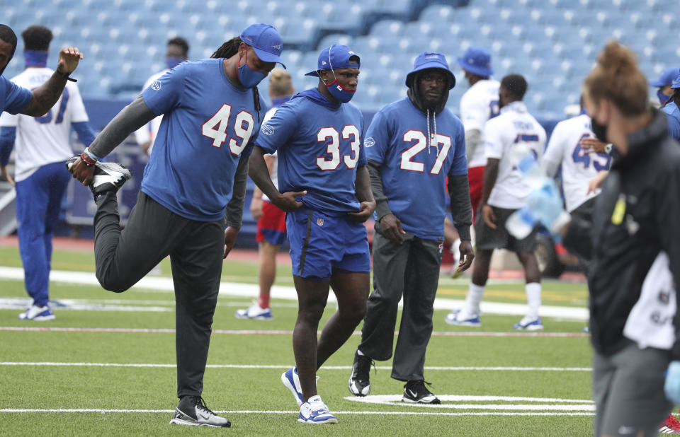 Buffalo Bills safety Siran Neal (33), Buffalo Bills linebacker Tremaine Edmunds (49) and Buffalo Bills cornerback Tre'Davious White (27) stretch during warm ups at practice at Bills Stadium in Orchard Park, N.Y. Wednesday, Sept. 2, 2020. (James P. McCoy /The Buffalo News via AP, Pool)