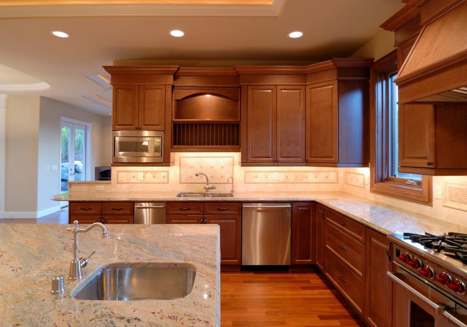 large kitchen with a long island and long countertops and cabinets
