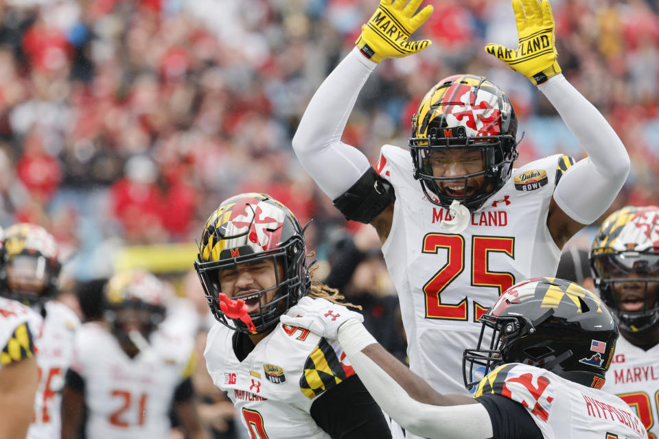 Maryland defensive back Beau Brade (25) celebrates with linebacker Fa'Najae Gotay, left, after Gotay intercepted a North Carolina State pass during the first half of the Duke's Mayo Bowl NCAA college football game in Charlotte, N.C., Friday, Dec. 30, 2022. (AP Photo/Nell Redmond)