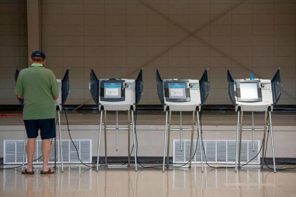 A voter uses an electronic voting machine to vote in the Mississippi primary election at a polling location in Jackson County on Tuesday, June 7, 2022. Individual counties in Mississippi can choose to use electronic or paper ballots. Hannah Ruhoff/hruhoff@sunherald.com