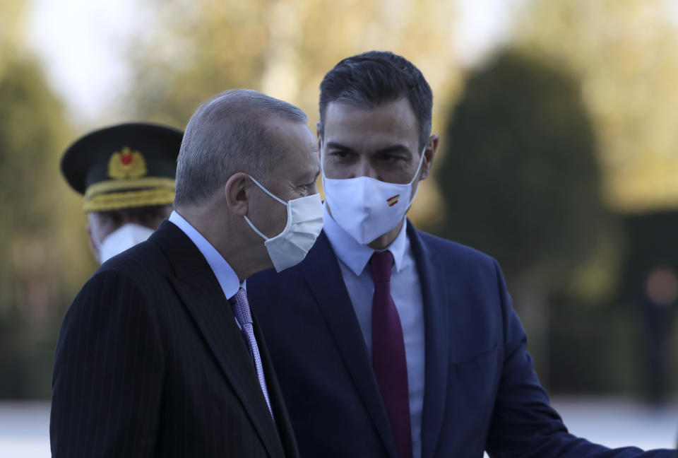 Turkey's President Recep Tayyip Erdogan, left, and Spanish Prime Minister Pedro Sanchez speak during a welcoming ceremony at the presidential palace, in Ankara, Turkey, Wednesday, Nov. 17, 2021. (AP Photo/Burhan Ozbilici)