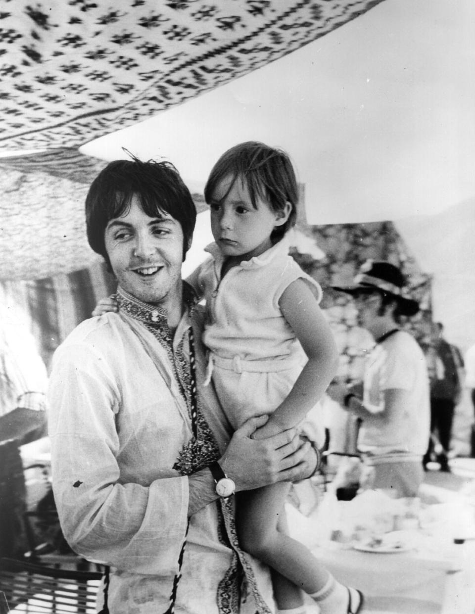 <p>Paul McCartney hangs out with his bandmate's four-year-old son while the band was on a break from tour in Greece. A few years later in 1969, Julian's father, John Lennon, would marry Yoko Ono. </p>