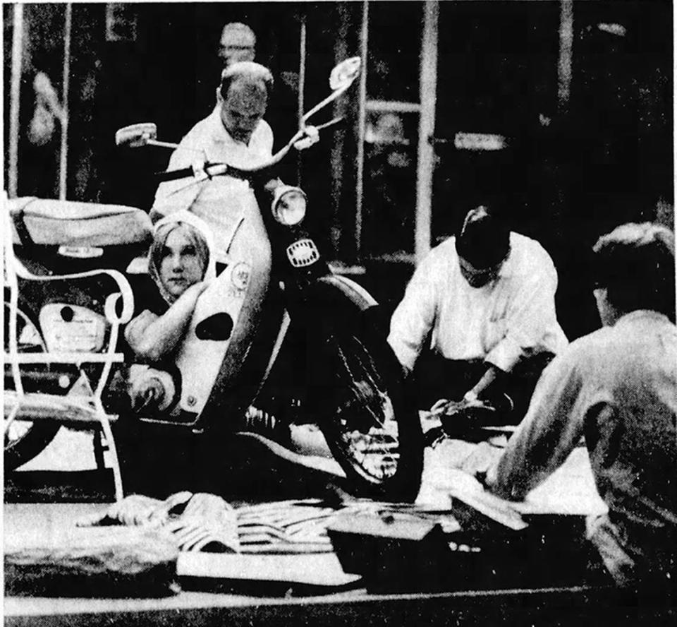 An artist’s model poses for drawers and painters on South Allen Street during the Central Pennsylvania Festival of the Arts in 1967.