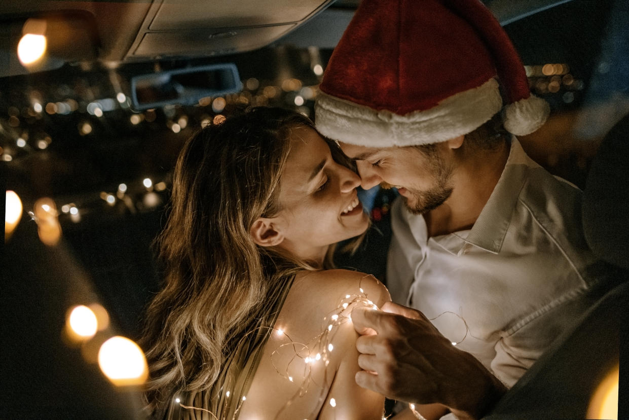 Photo of young couple having holiday hookup in the car.