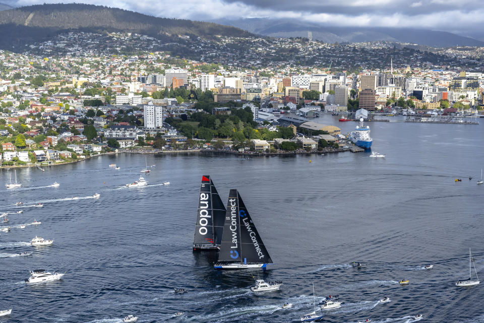 Super maxis Comanche, left, and LawConnect duel for the lead near the finish of the Sydney Hobart yacht race in Hobart, Australia, Thursday, Dec. 28, 2023. LawConnect wins the battle to finish to take line honors in the 630-nautical mile race. (Kurt Arrigo/Rolex/CYCA via AP)