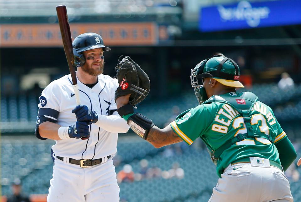 Tigers right fielder Robbie Grossman looks at the umpire after striking out and being tagged by Athletics catcher Christian Bethancourt on a foul tip during the third inning of Game 1 of a doubleheader on Tuesday, May 10, 2022, at Comerica Park.