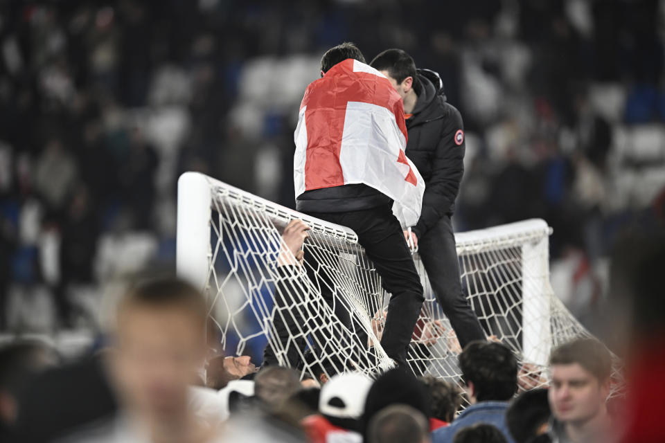 Georgia's fans celebrate the victory of their team in the Euro 2024 qualifying play-off soccer match between Georgia and Greece at the Boris Paichadze National Stadium in Tbilisi, Georgia, Tuesday, March 26, 2024. (AP Photo/Tamuna Kulumbegashvili)