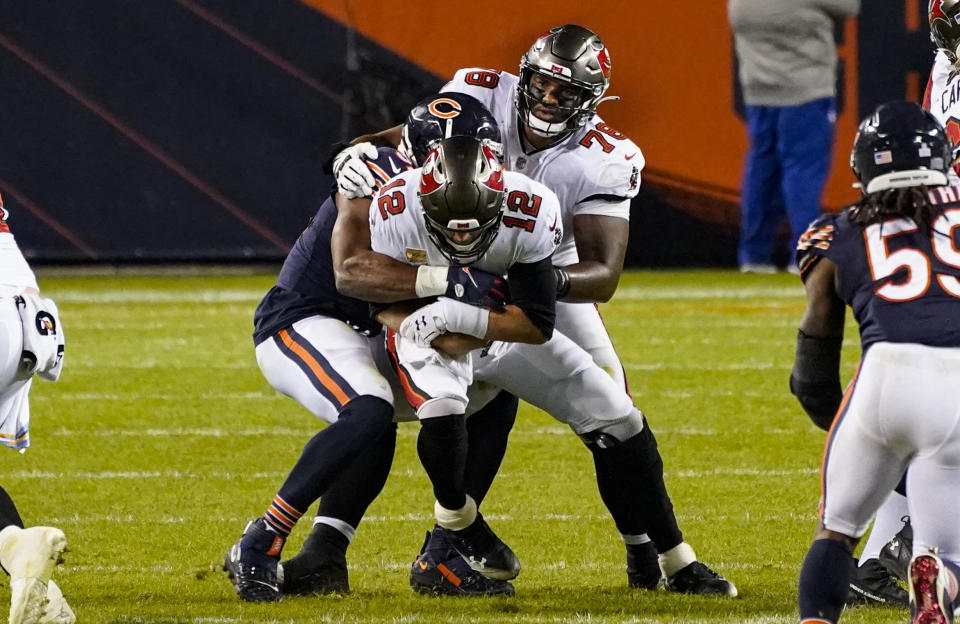 Tampa Bay Buccaneers quarterback Tom Brady (12) is sacked by Chicago Bears outside linebacker Khalil Mack (52) during the second half of an NFL football game in Chicago, Thursday, Oct. 8, 2020. (AP Photo/Nam Y. Huh)