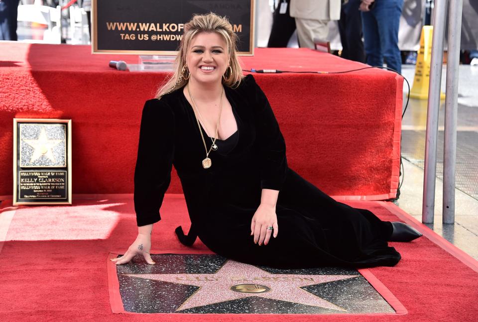 Singer and talk show host Kelly Clarkson poses atop her new star on the Hollywood Walk of Fame during a ceremony in Los Angeles Sept. 19, 2022.