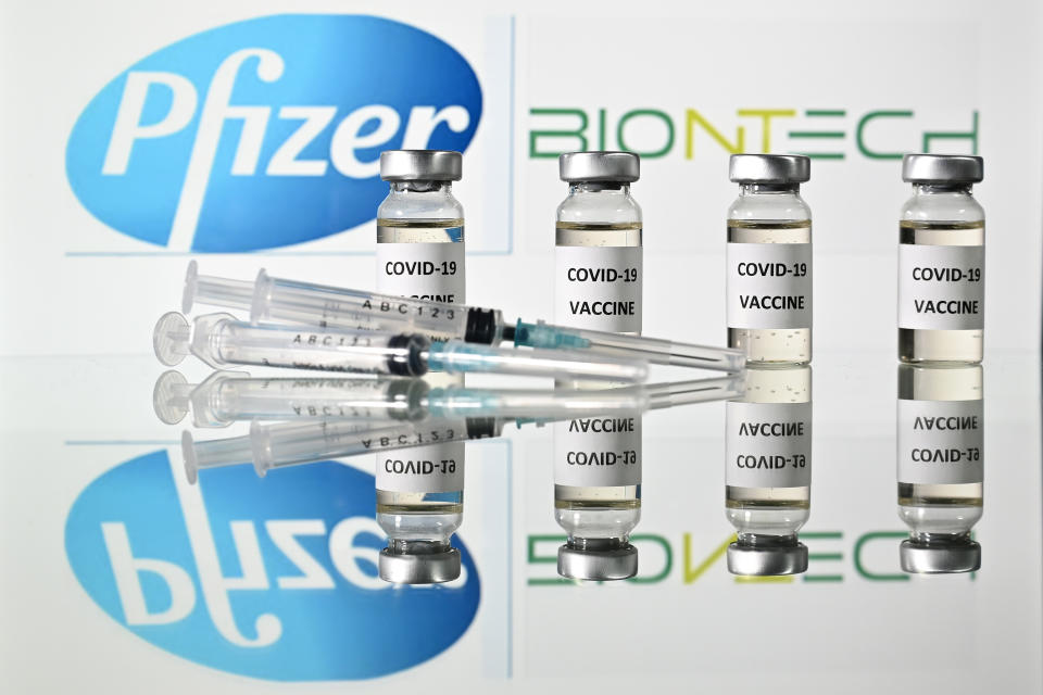 An illustration picture shows vials with Covid-19 Vaccine stickers attached and syringes with the logo of US pharmaceutical company Pfizer and German partner BioNTech, on November 17, 2020. (Photo by JUSTIN TALLIS / AFP) (Photo by JUSTIN TALLIS/AFP via Getty Images)