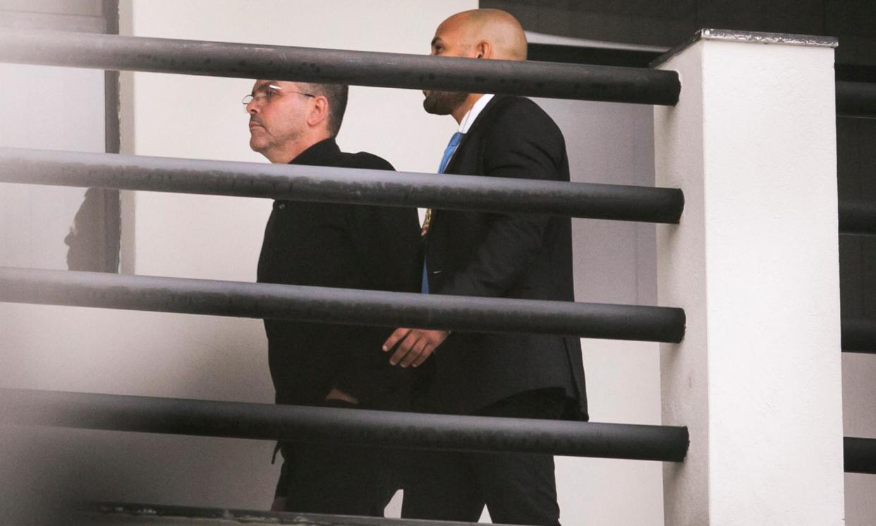 <span>The former head of the Rio civil police, Rivaldo Barbosa, left, is escorted by a police officer upon arrival at the federal police headquarters in Rio de Janeiro on Sunday.</span><span>Photograph: Daniel Ramalho/AFP/Getty Images</span>