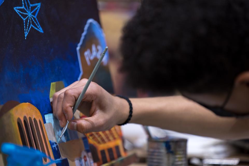 Chance Bailey Johnson, a 15-year-old local artist, carefully works on details of his acrylic painting of Downtown El Paso cityscape at Art Nova Gallery at Sunland Park Mall on Feb. 16.