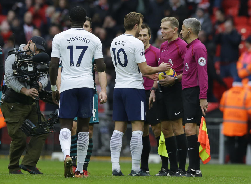 Harry Kane claims the match ball from the ref