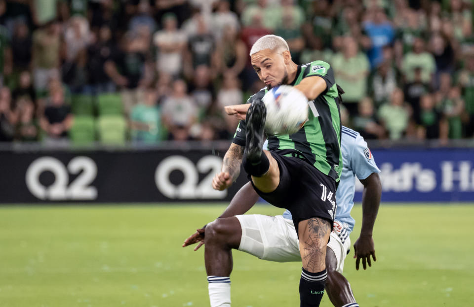 Austin FC midfielder Diego Fagundez (14) makes a bicycle kick during the first half of an MLS playoff soccer match against FC Dallas, Sunday, Oct. 23, 2022, in Austin, Texas. (AP Photo/Michael Thomas)