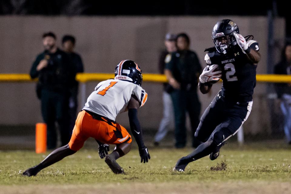 Buchholz Bobcats middle linebacker Myles Graham (2) runs past Lakeland Dreadnaughts free safety Keon Young (1) during the first half in the Semifinals of the 2023 FHSAA Football State Championships at Citizens Field in Gainesville, FL on Friday, December 1, 2023. [Matt Pendleton/Gainesville Sun]