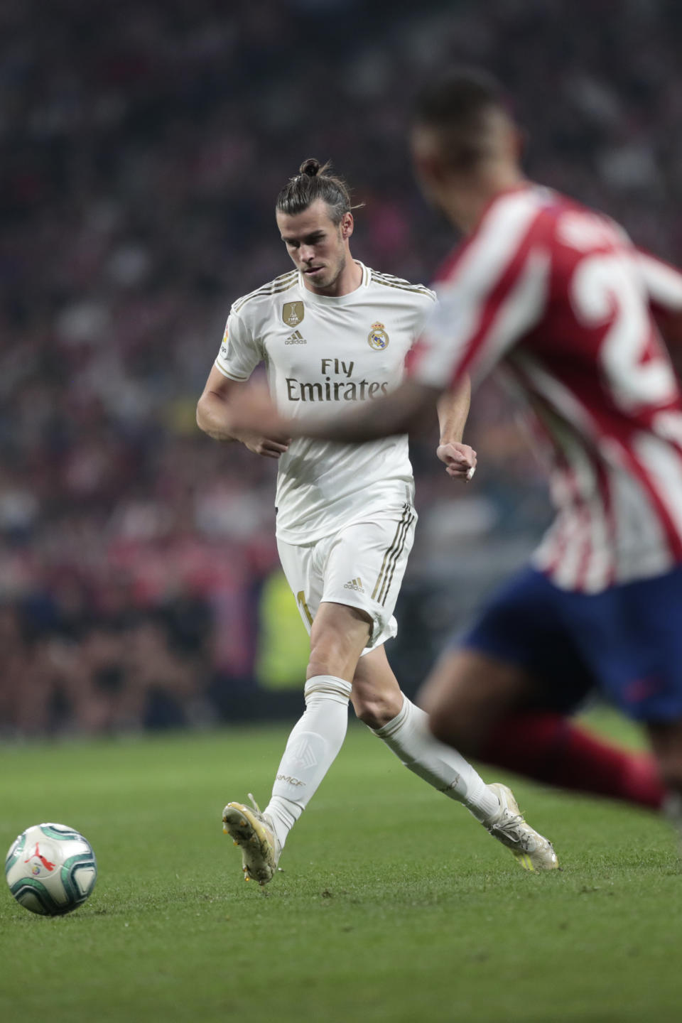 Real Madrid's Gareth Bale plays the ball during the Spanish La Liga soccer match between Atletico Madrid and Real Madrid at the Wanda Metropolitano stadium in Madrid, Saturday, Sept. 28, 2019. (AP Photo/Bernat Armangue)