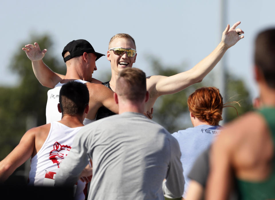 Sam Kendricks, center, celebrates with fellow competitors after clearing his final attempt during the men's pole vault at the U.S. Championships athletics meet, Saturday, July 27, 2019, in Des Moines, Iowa. (AP Photo/Charlie Neibergall)
