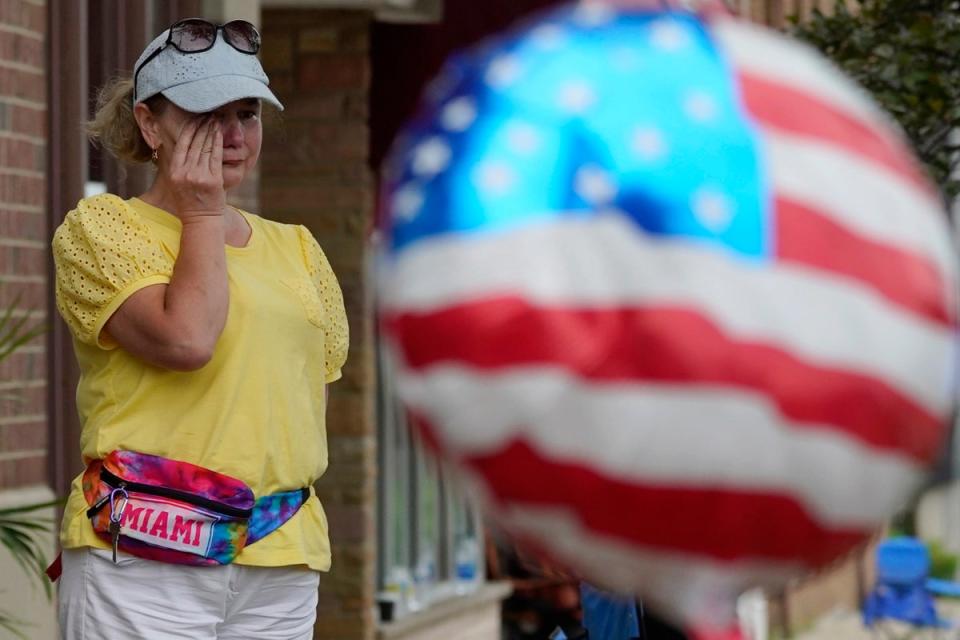 Woman wipes away tears at the scene of the mass shooting (Copyright 2022 The Associated Press. All rights reserved.)