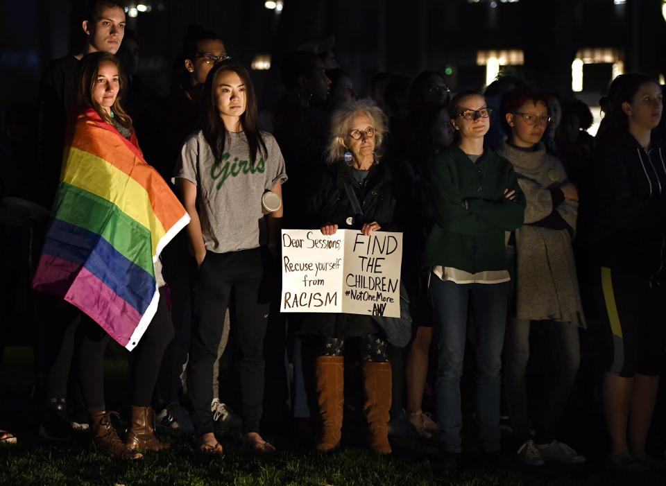 Protesters gather on a green near Johnson Chapel, where former attorney general Jeff Sessions is speaking, at Amherst College in Amherst, Mass., Wednesday, April 24, 2019. (AP Photo/Jessica Hill)