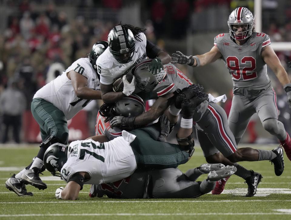 Nov. 11, 2023; Columbus, Oh., USA; 
Michigan State Spartans tight end Maliq Carr (6) is tackled by Ohio State Buckeyes cornerback Calvin Simpson-Hunt (15) and Ohio State Buckeyes linebacker C.J. Hicks (11) during Saturday's NCAA Division I football game at Ohio Stadium.