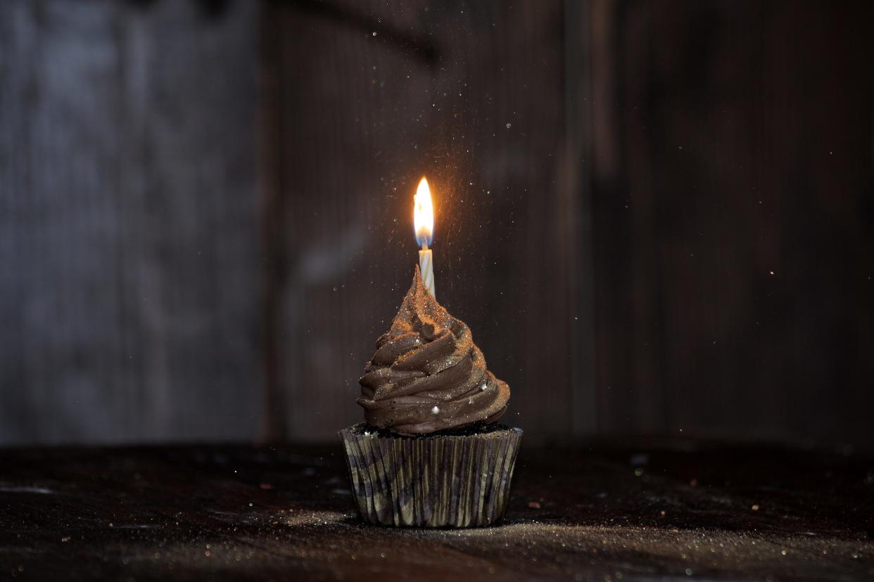 glitter dusted chocolate cupcake with birthday candle