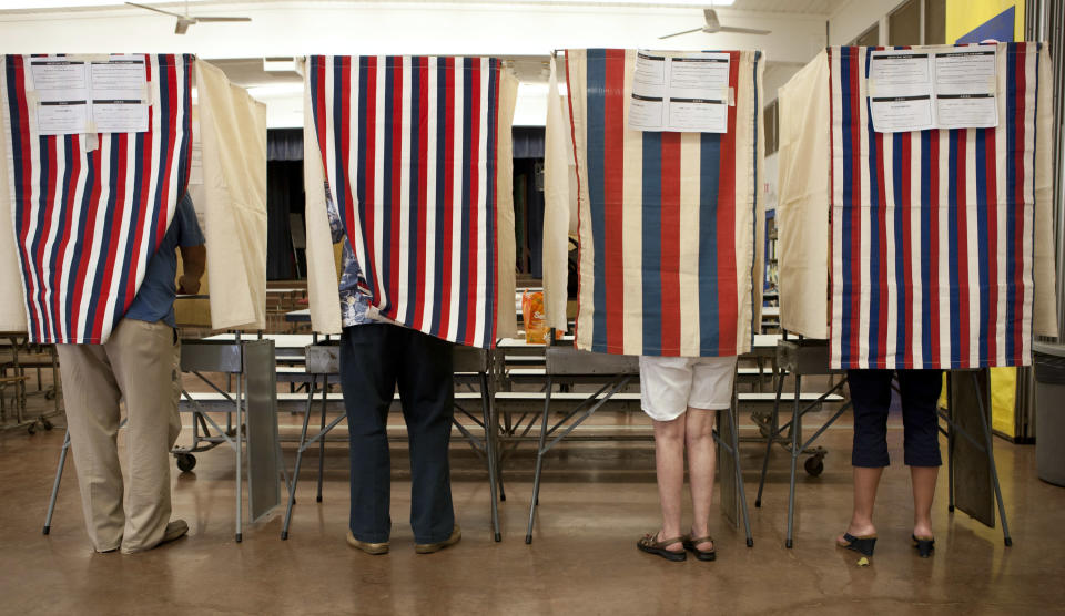 Voters cast their ballots at Waikiki Elementary on Election Day, Tuesday, Nov. 6, 2012 in Honolulu. (AP Photo/Marco Garcia)