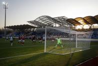 In this photo taken on Friday, March 27, 2020, Belshina's Bobruisk goalkeeper Sergei Turanok gets ready to save the ball during the Belarus Championship soccer match between Torpedo-BelAZ Zhodino and Belshina Bobruisk in the town of Zhodino, Belarus. Longtime Belarus President Alexander Lukashenko is proudly keeping soccer and hockey arenas open even though most sports around the world have shut down because of the coronavirus pandemic. The new coronavirus causes mild or moderate symptoms for most people, but for some, especially older adults and people with existing health problems, it can cause more severe illness or death. (AP Photo/Sergei Grits)