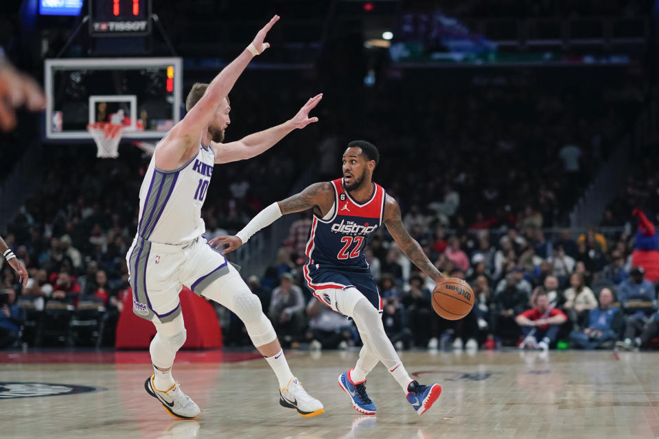 Washington Wizards guard Monte Morris (22) dribbles the ball as Sacramento Kings forward Domantas Sabonis (10) defends during the first half of an NBA basketball game Saturday, March 18, 2023, in Washington. (AP Photo/Jess Rapfogel)