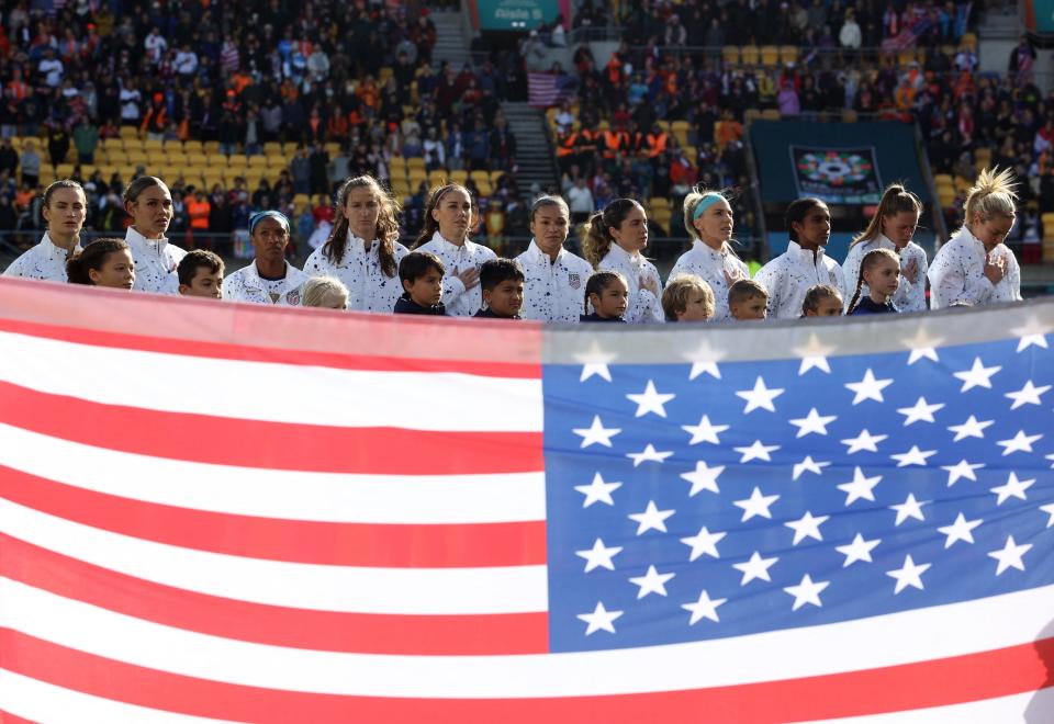 The USWNT stands for the national anthem ahead of a 2023 World Cup match.
