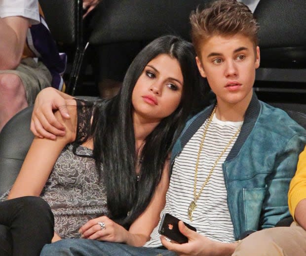 Selena Gomez and Justin Bieber attend a basketball game between the San Antonio Spurs and the Los Angeles Lakers at Staples Center on <a href="https://parade.com/1360954/jessicasager/april-holidays-observances/" rel="nofollow noopener" target="_blank" data-ylk="slk:April;elm:context_link;itc:0;sec:content-canvas" class="link ">April</a> 17, 2012.<p>Noel Vasquez/Getty Images</p>