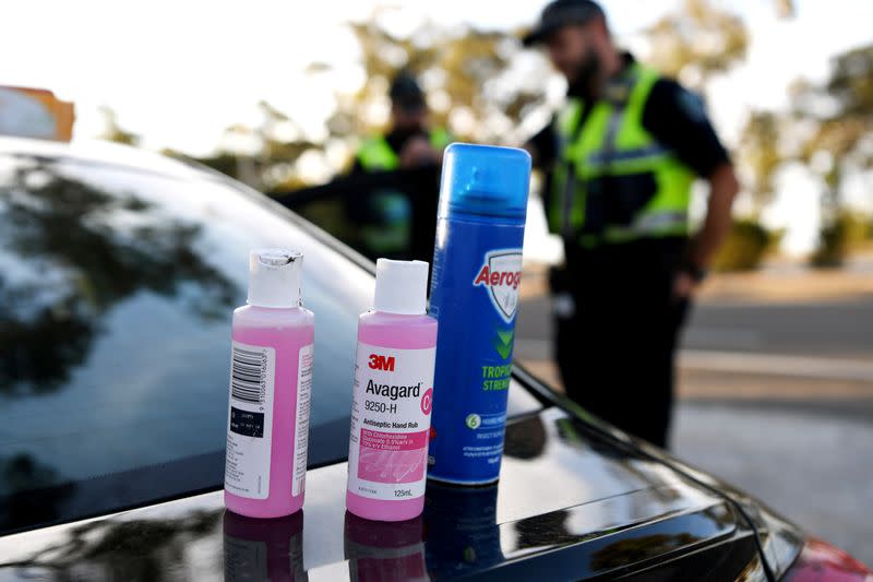 Disinfectant products are seen on a car whilst motorists fill out paperwork for police as they cross back into South Australia from Victoria during the coronavirus disease (COVID-19) outbreak, in Bordertown