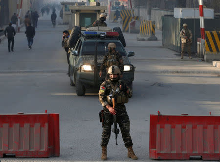 Afghan security forces keep watch at a check point close to the compound of Afghanistan's national intelligence agency in Kabul, Afghanistan. December 25, 2017. REUTERS/Omar Sobhani