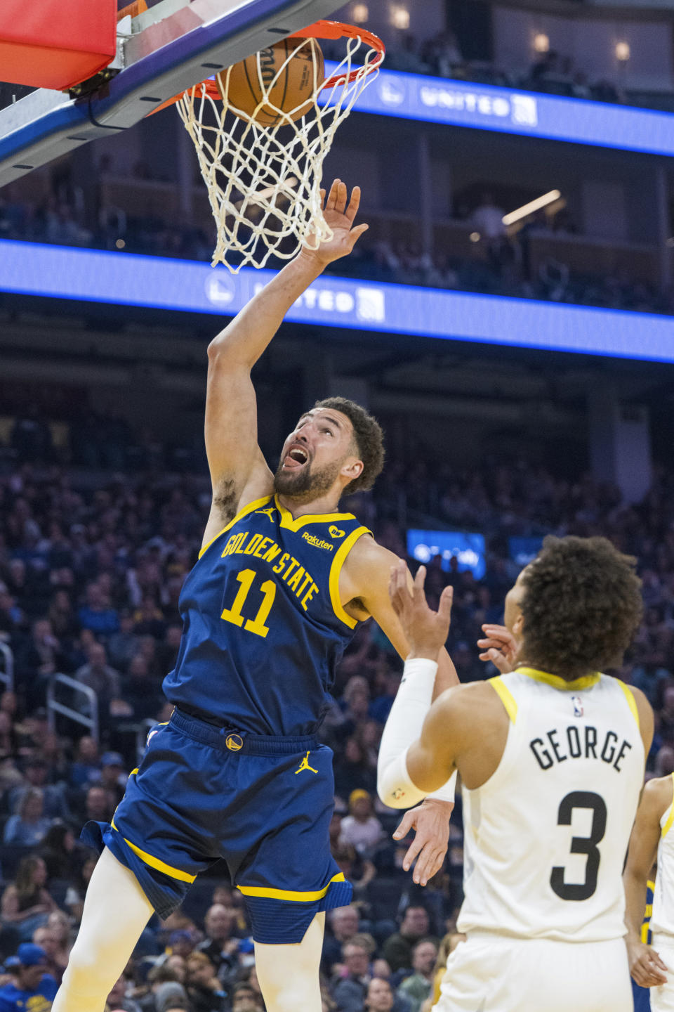 Utah Jazz guard Keyonte George (3) watches a dunk by Golden State Warriors guard Klay Thompson (11) during the first half of an NBA basketball game, Sunday, April 7, 2024, in San Francisco. (AP Photo/Nic Coury)