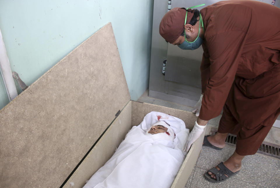 The body of Nimat Rawan, a former Afghan TV presenter, lies in morgue at a hospital in Kandahar, Afghanistan, Tuesday, May 6, 2021. Gunmen killed Rawan on Thursday as he was traveling in the southern city of Kandahar, a provincial official said, adding to fears for press freedom in the war-wrecked country. (AP Photo/Sidiqullah Khan)