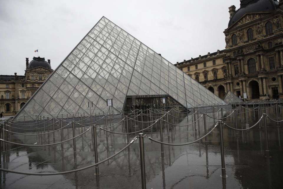 The security line outside the Louvre museum is empty in Paris, Monday, March 2, 2020. The Louvre was closed as management was meeting with staff worried about the spread of the new virus in the world's most-visited museum. (AP Photo/Christophe Ena)
