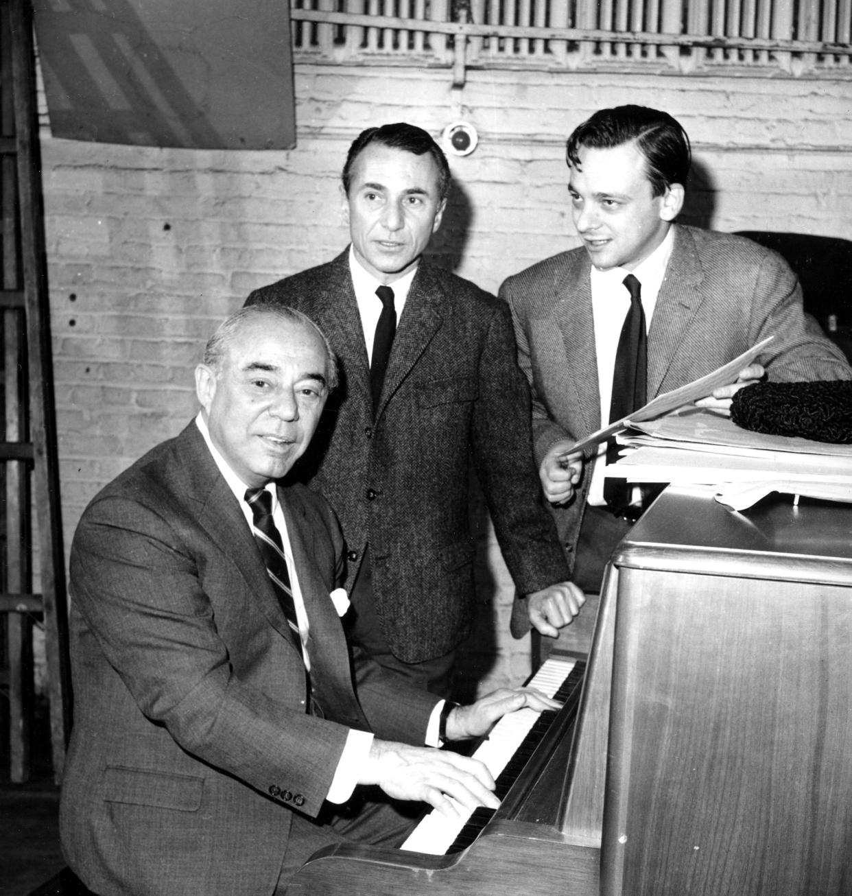 FILE - In this Dec. 28, 1964 file photo, composer Richard Rodgers, at the piano, his new collaborator, lyricist Stephen Sondheim, right, and playwright Arthur Laurents are shown as they begin work on the new musical "Do I Hear a Waltz?" in New York. The musical was being adapted from Laurents' book "Summertime." 