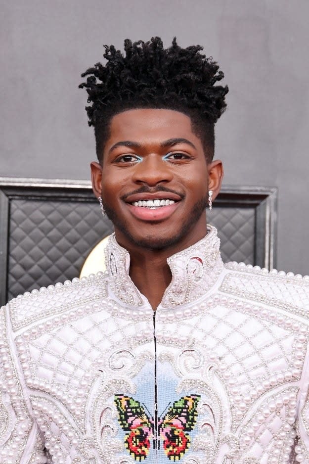 Lil Nas X poses on the Grammys red carpet in 2022