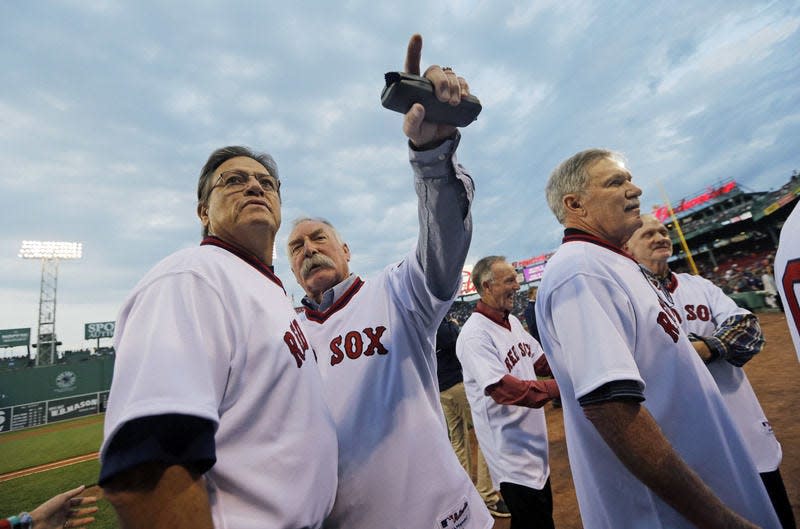 Boston Red Sox former catcher Carlton Fisk, far left, chats with former teammates during pre-game ceremonies at Fenway Park in Boston, Tuesday, May 5, 2015 honoring the 1975 Boston Red Sox baseball team which won the American League pennant. (AP Photo/Elise Amendola)