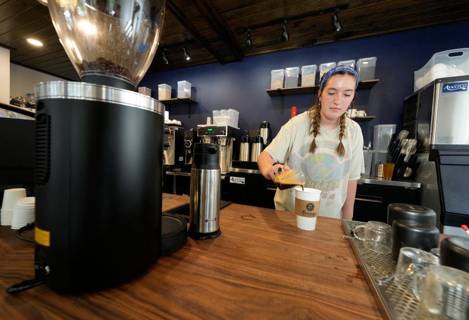 Kloey Snow prepares a cappuccino at Trilogy Kitchen in DeLand, a new breakfast and lunch spot started by the founders and operators of Trilogy Coffee Roasting Co.