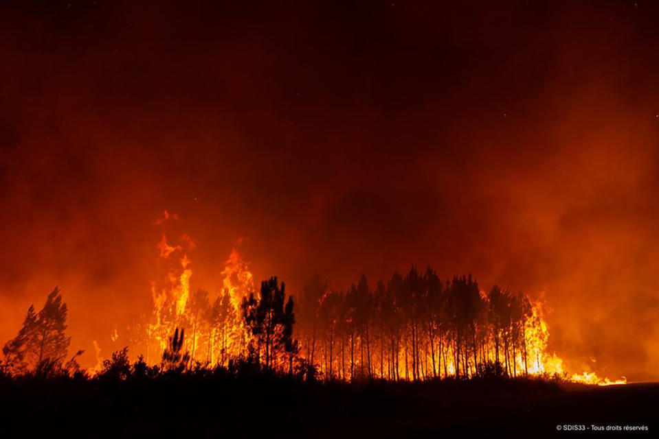 This photo provided by the fire brigade of the Gironde region SDIS 33, (Departmental fire and rescue service 33) shows a blaze burning near Saint-Magne, south of Bordeaux, southwestern France, Wednesday, Aug. 10, 2022. (SDIS 33 via AP)