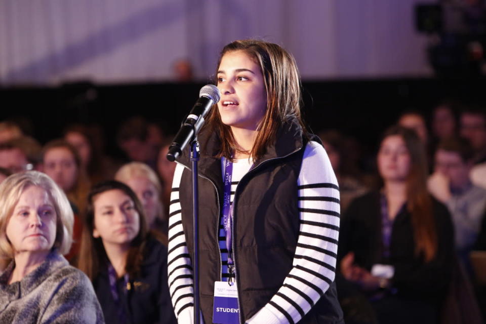 A student poses a question to the panel.