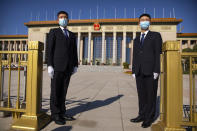 Security officials wearing face masks stand guard outside the Great Hall of the People before an event to honor some of those involved in China's fight against COVID-19 in Beijing, Tuesday, Sept. 8, 2020. Chinese leader Xi Jinping is praising China's role in battling the global coronavirus pandemic and expressing support for the U.N.'s World Health Organization, in a repudiation of U.S. criticism and a bid to rally domestic support for Communist Party leadership. (AP Photo/Mark Schiefelbein)