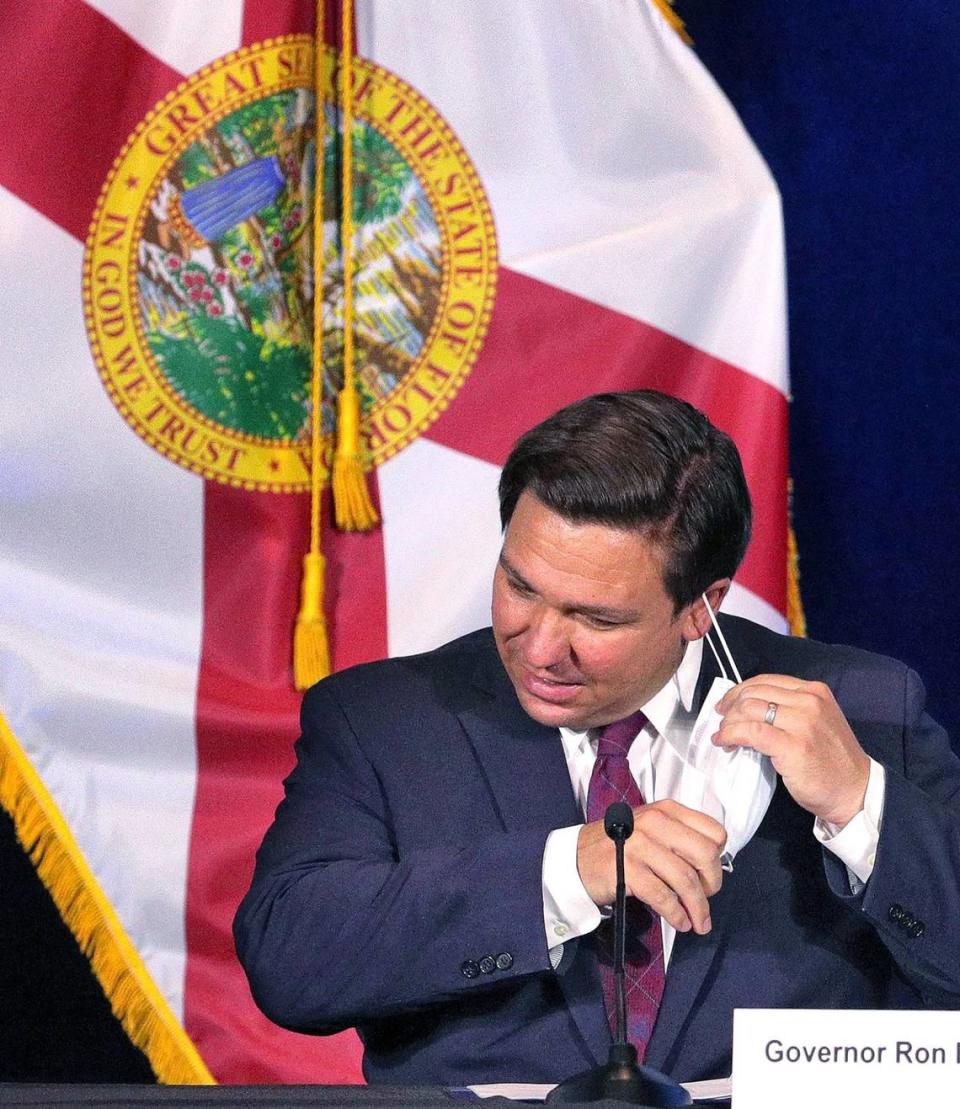 Gov. Ron DeSantis removes his mask after arriving at Universal Studios Florida in Orlando to participate in a roundtable discussion with theme park leaders about safety protocols and the impact of the coronavirus pandemic, Wednesday, August 26, 2020. Executives from Walt Disney World, Universal Orlando and SeaWorld Orlando delivered remarks and answered questions from the governor.