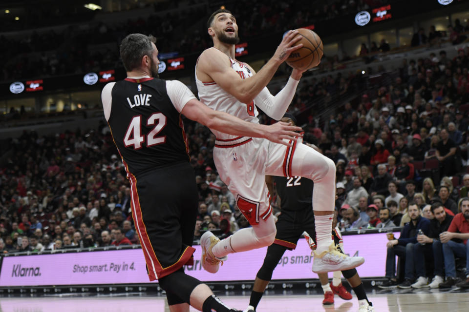 Chicago Bulls' Zach LaVine (8) goes up for a shot against Miami Heat's Kevin Love (42) during the first half of an NBA basketball game, Saturday, March 18, 2023, in Chicago. (AP Photo/Paul Beaty)