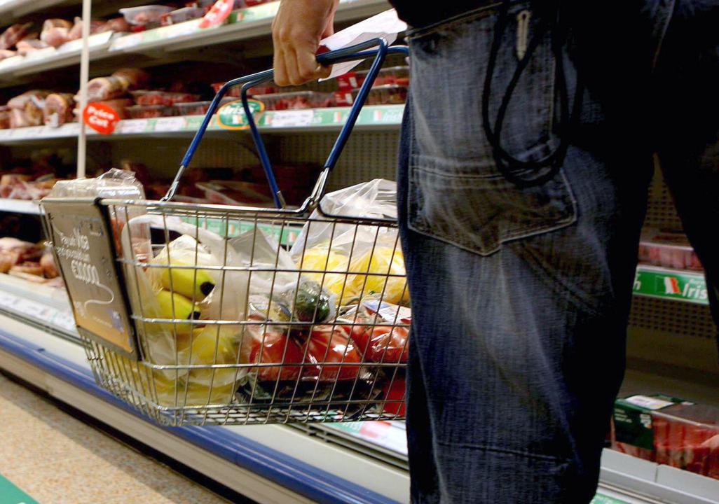 Undated file photo of a person holding a shopping basket in a supermarket. According to figures from the British Retail Consortium-NielsenIQ Shop Price Index, shop price inflation is showing signs of normalising one year on from its peak. Figures have slowed to 3.4%, its lowest growth since March 2022 and the 12th consecutive drop. Issue date: Tuesday April 30, 2024.