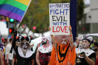 <p>Members of the Sisters of Perpetual Indulgence carry a sign of remembrance for the mass shooting victims in Orlando, at the 46th annual Los Angeles Gay Pride Parade in West Hollywood, June 12, 2016. (Reuters/David McNew) </p>