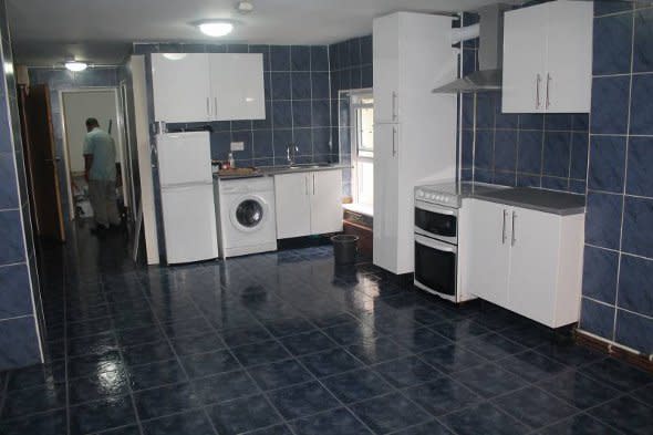 The kitchen area of the tiled flat.