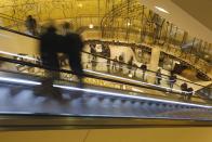 People use an escalator at a shopping mall in Essen November 30, 2013. The busy Christmas shopping season traditionally begins on the first Advent weekend in Germany. REUTERS/Ina Fassbender