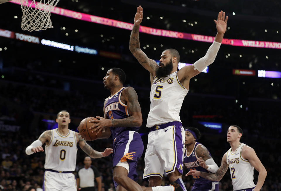 Phoenix Suns' Trevor Ariza, second from left, drives past Los Angeles Lakers' Tyson Chandler (5) during the first half of an NBA basketball game Sunday, Dec. 2, 2018, in Los Angeles. (AP Photo/Marcio Jose Sanchez)